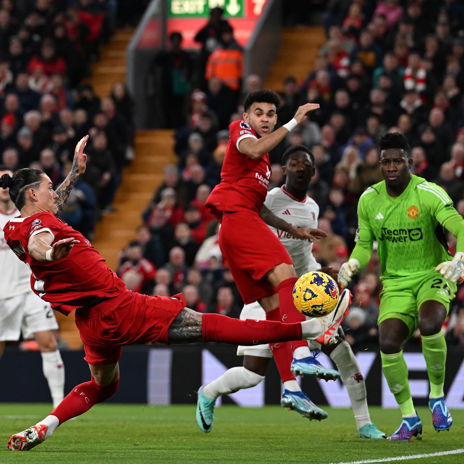 May be an image of 3 people, people playing football, people playing soccer and crowd