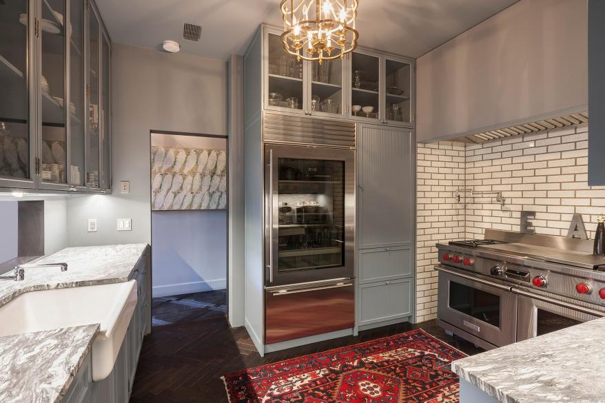 A chefs kitchen with stainless-steel appliances.