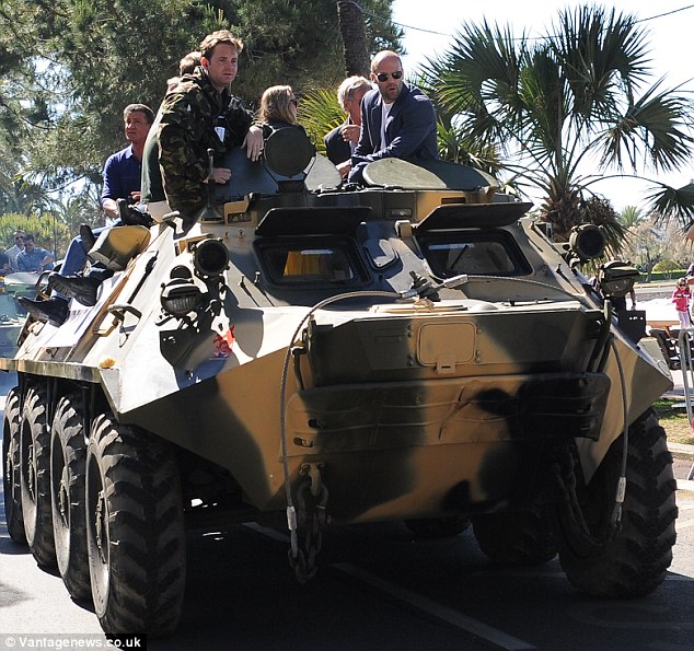 Fun ride: The stars seemed to enjoy the tank stunt on the Promenade de la Croisette