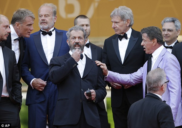 Beard to the bone: Mel is seen touching his facial hair as he takes a pause to collect his thoughts on the red carpet