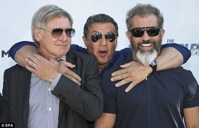 Bromance: Stallone hugged Ford and Gibson from behind as the three action stars posed for a snap