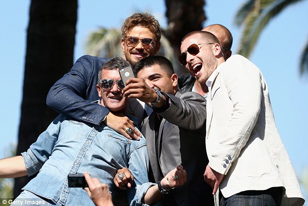 Selfie time: Banderas, Kellen Lutz, Victor Ortiz, and Glen Powell - pictured from left to right - posed for a fun self-taken shot at the event