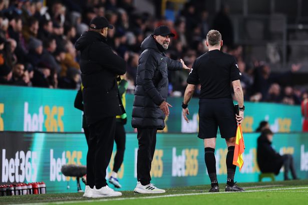 Jürgen Klopp, Manager of Liverpool, interacts with Assistant Referee Scott Ledger during the Premier League match between Burnley FC and Liverpool FC at Turf Moor on December 26, 2023 in Burnley, England.