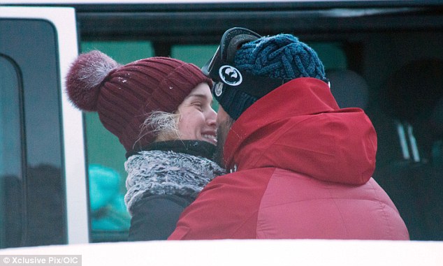 Give us a kiss: Jason leaned in and lavished his girlfriend with love as they kept each other warm