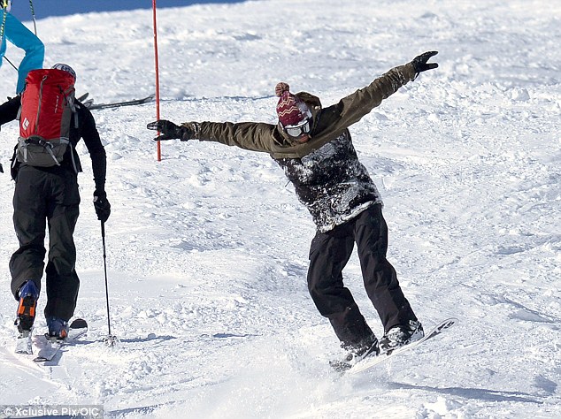 Action man: Jason flew down the mountain as he tried out some tricks on one of his last days in the snow