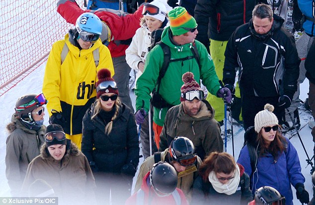 Blending in: The pair stood in the crowds as they let their hair down for the holidays