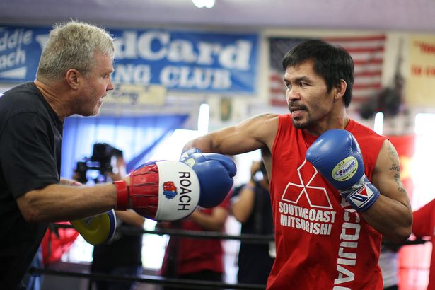 Manny Pacquiao works out with his trainer Freddie Roach