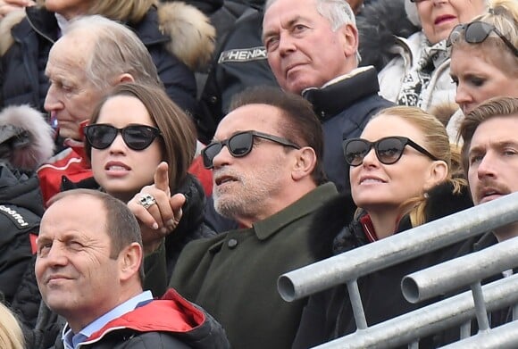 Arnold Schwarzenegger between his daughter Christina and his partner Heather Milligan attend the Audi FIS Alpine Ski World Cup Men's Slalom at Ganslern Alm in Kitzbühel, Austria, January 26, 2020.