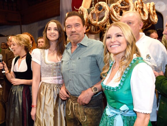 Arnold Schwarzenegger between his daughter Christina and his partner Heather Milligan during the 29th Weisswurstparty at the Stanglwirt Hotel in Going, Austria, on January 27, 2020.