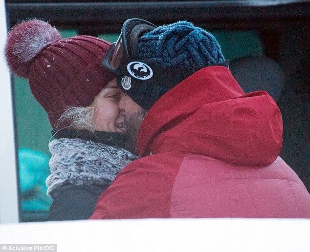 Snow-mance: Rosie Huntington-Whiteley plants a kiss on boyfriend Jason Statham as they enjoy a romantic skiing trip in the French Alps together