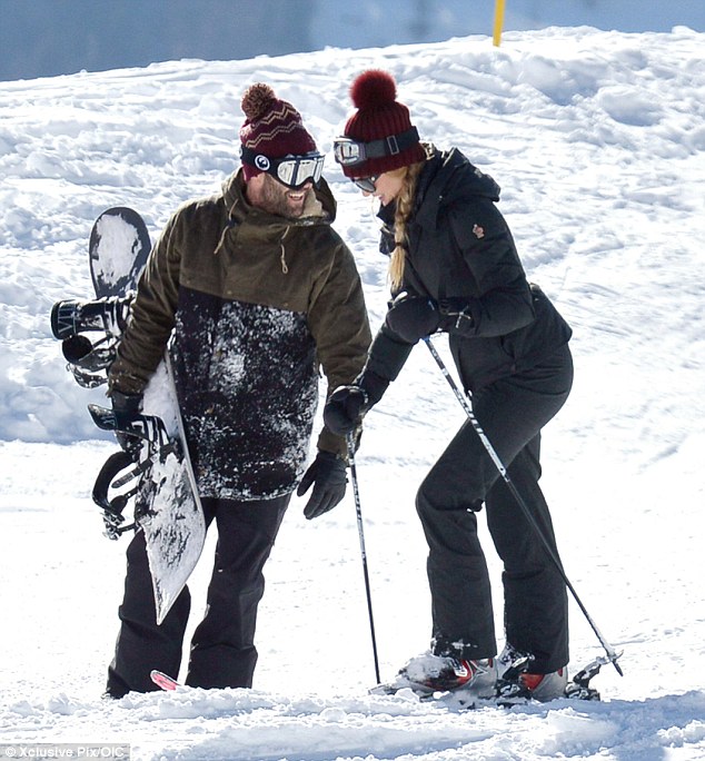 They're just snow suited: The pair wore matching burgundy bobble hats as they took to the slopes together