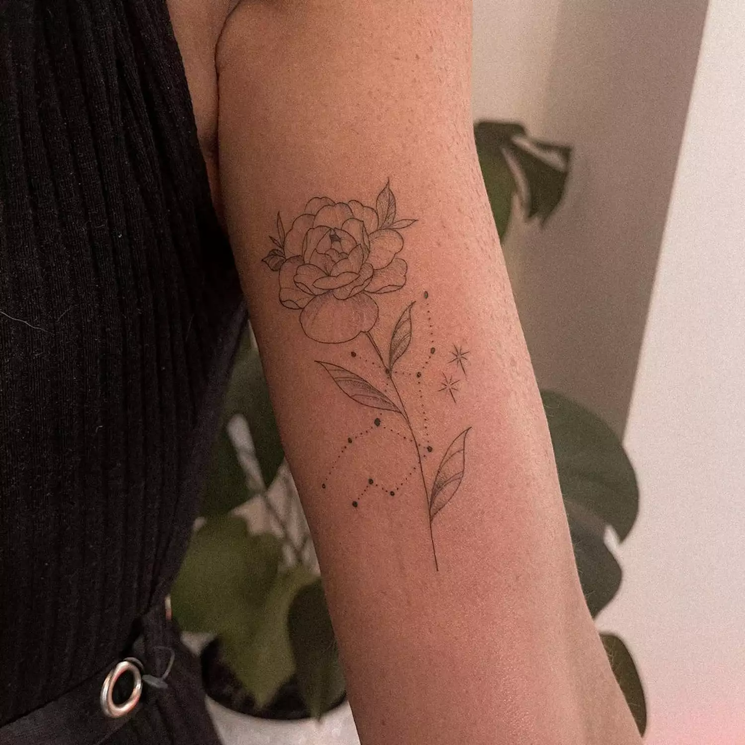 A Virgo constellation with a rose tattoo