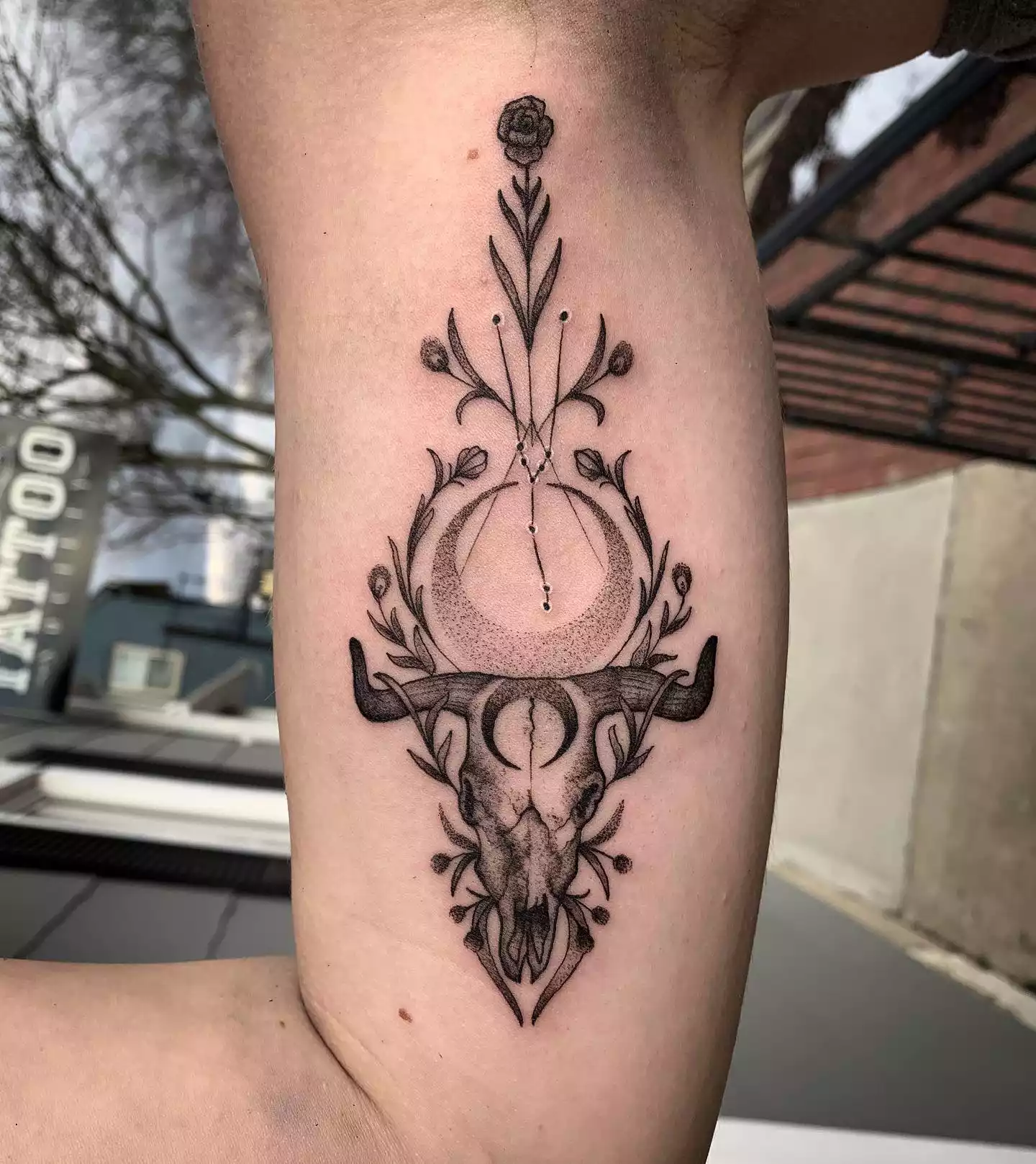 Image of a Taurus bull tattoo with a floral motif