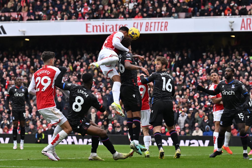 Arsenal's Brazilian defender #06 Gabriel Magalhaes (C) heads the ball as he scores his team first goal during the English Premier League football match between Arsenal and Crystal Palace at the Emirates Stadium in London on January 20, 2024. (Photo by BEN STANSALL/AFP via Getty Images)