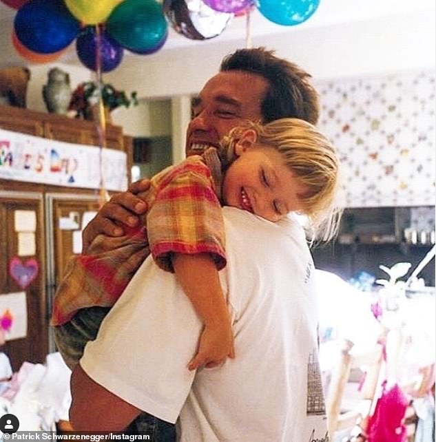 Doting dad: The movie star's son Patrick shared a photo of himself as a toddler cuddling his dad on a Father's Day from his childhood. 'Love you big guy @schwarzenegger,' he wrote