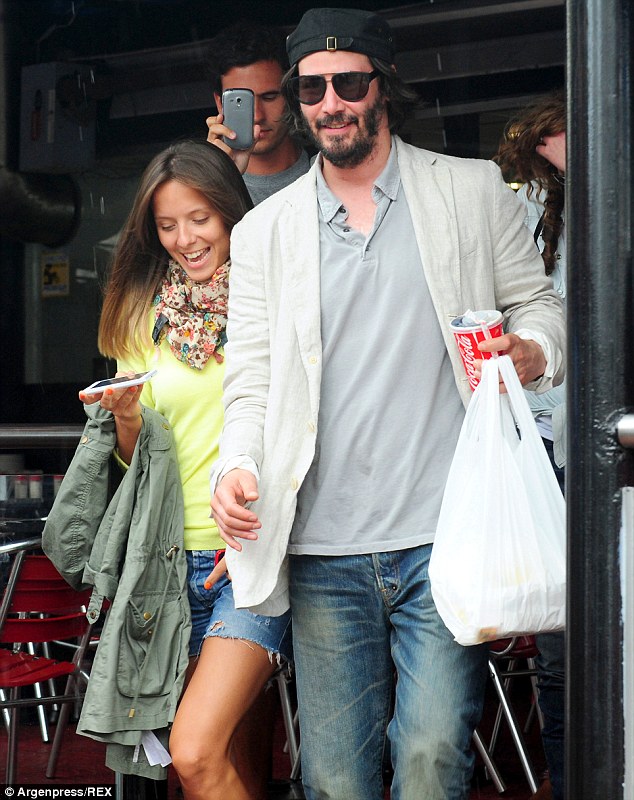 Snap happy: Keanu didn't seem to mind too much about being besieged by fans with camera phones