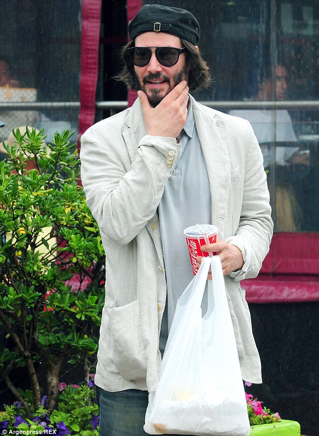 Happy: Keanu Reeves was spotted looking smiling and relaxed as he strolled around the coastal town of Punta del Esta in Uruguay on Monday ahead of a friend's wedding