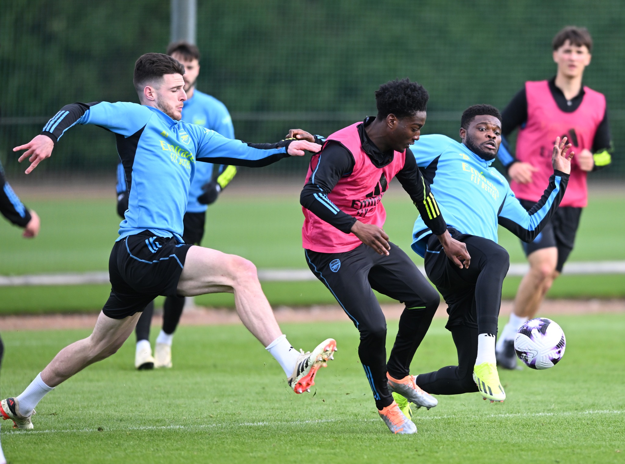 May be an image of 4 people, people playing football, people playing American football and studded shoes