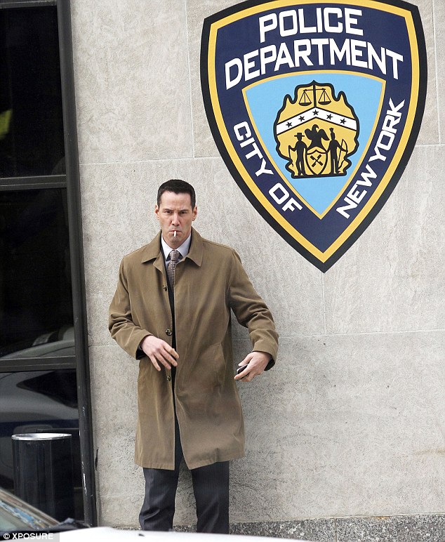 The finest: The actor plays in detective in the film, which was made even more evident as he posed in front of a building with a sign for the NYPD