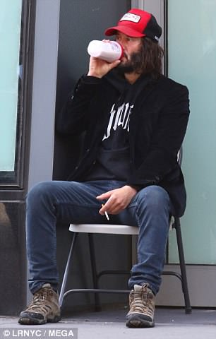 And relax: Keanu, whose titular character will go on the run in the forthcoming film, shielded himself beneath a baseball cap as he took a smoke break on a street corner after training for the highly physical role