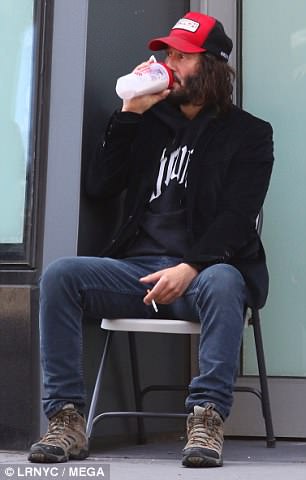 And relax: Keanu, whose titular character will go on the run in the forthcoming film, shielded himself beneath a baseball cap as he took a smoke break on a street corner after training for the highly physical role