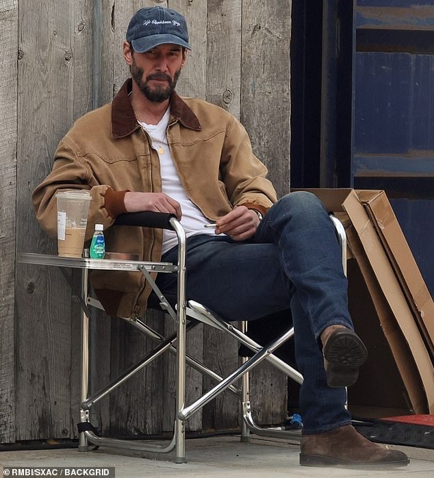 Keanu Reeves while enjoying a bit of downtime on the Malibu set of his upcoming film Outcome on Saturday afternoon