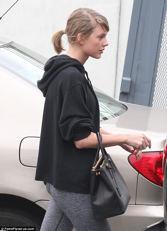 Worked up a sweat: Taylor swept her fair tresses into a casual ponytail and carried an expensive Prada handbag