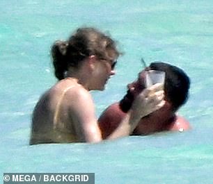 Photographers caught the pair, both 34, packing on the PDA while enjoying the sunshine on the island on Thursday