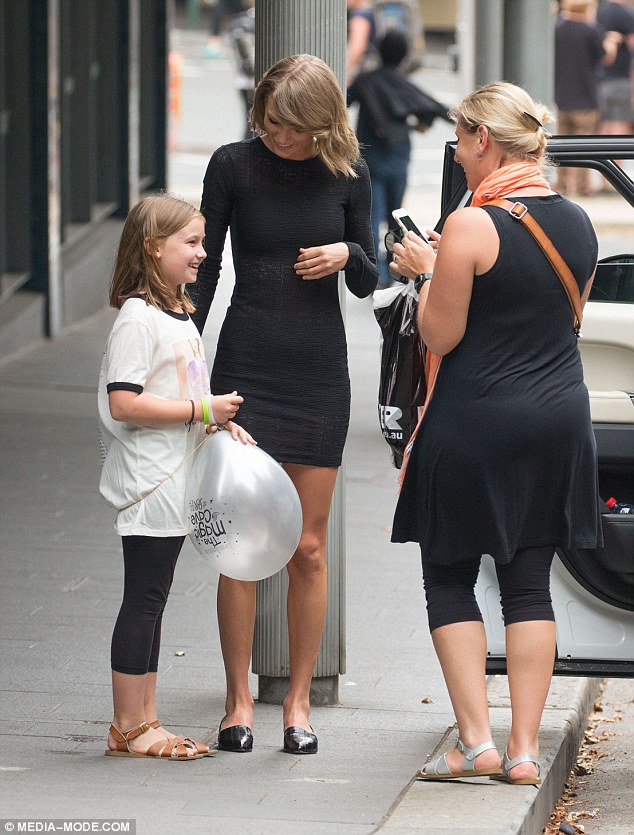 Delighted: Taylor was more than happy to stop to chat to the youngster and her mother in Sydney's Surry Hills