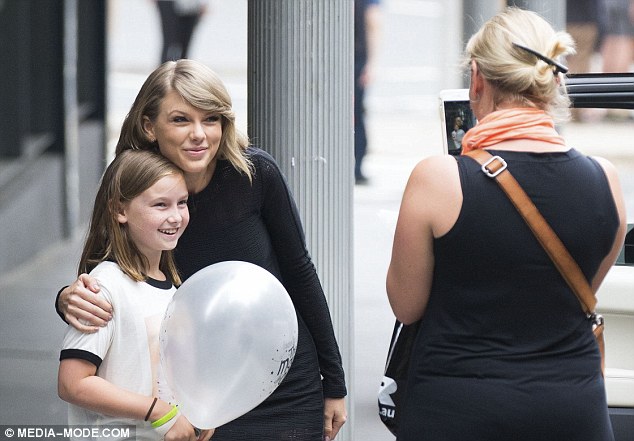 Beaming: The little girl could barely contain her joy as the 25-year-old starlet posed for photographs with her 