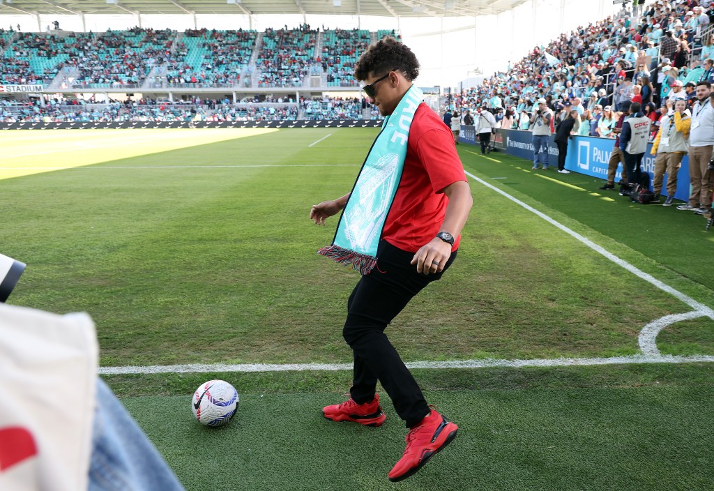 Kansas City Chiefs quarterback Patrick Mahomes dribbles a soccer ball prior to the match between the Portland Thorns FC and the Kansas City Current