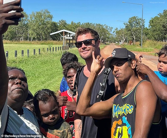 Photographs shared to social media by Wugularr School showed the Hollywood star posing for photographs with excited students and teachers during the visit