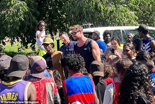 He cut a casual figure in a black vest top and shorts as he was mobbed by crowds of excited locals who flocked out en masse for the chance to meet Chris