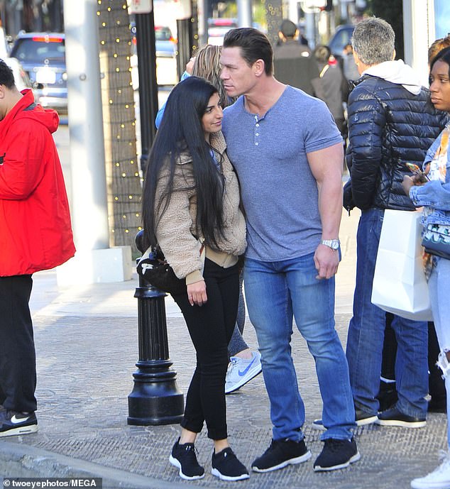 Love up close: John Cena and girlfriend Shay Shariatzadeh were snapped in Beverly Hills, California Tuesday afternoon, snuggling up on a street corner while they were waiting to cross