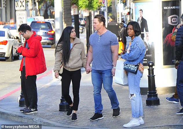 Stepping out: His lady love wore a tan fleece top and black leggings, with her straight, long dark hair hanging down over her shoulder