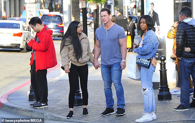 Casual day fashion: The Blockers actor was dressed in a short-sleeved grey henley top, which he filled out impressively with his muscly physique, and denim bluejeans