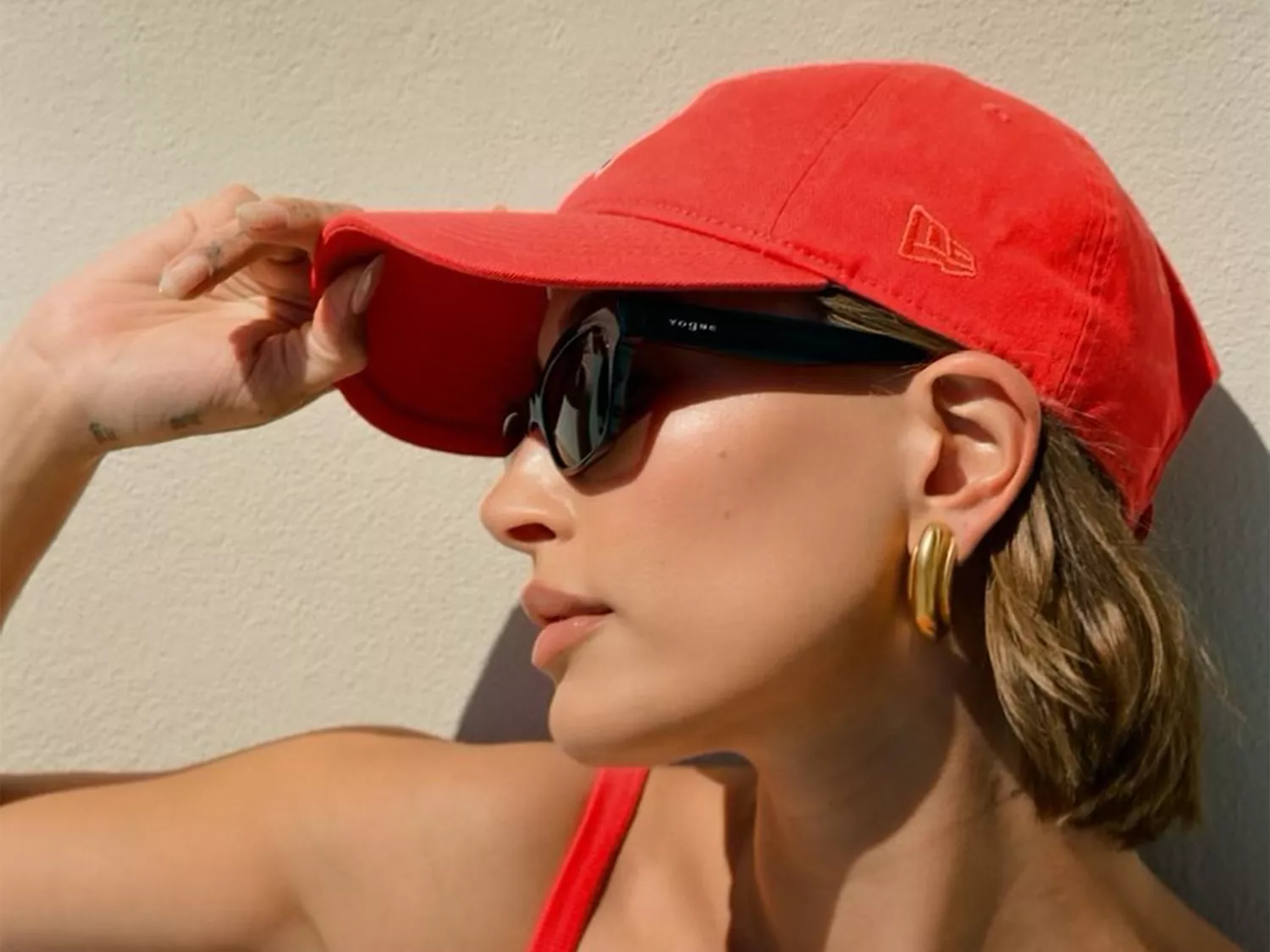 hailey bieber in red hat showing wrist tattoo