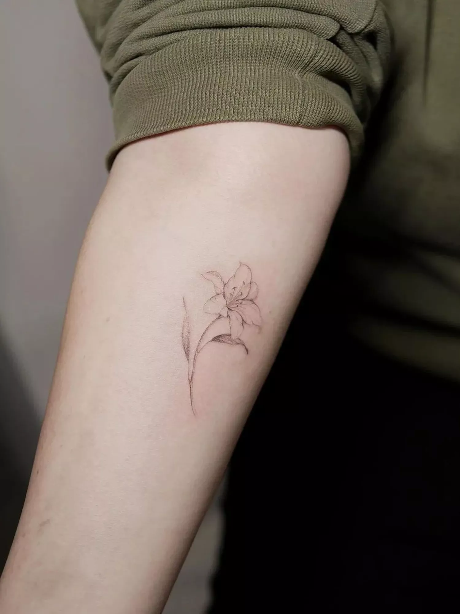 forearm with flower tattoo