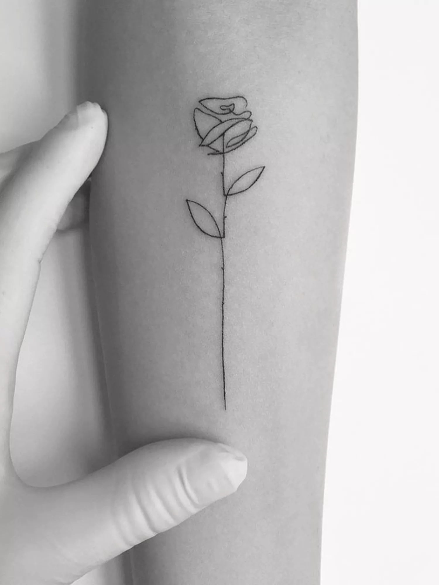 forearm with flower tattoo