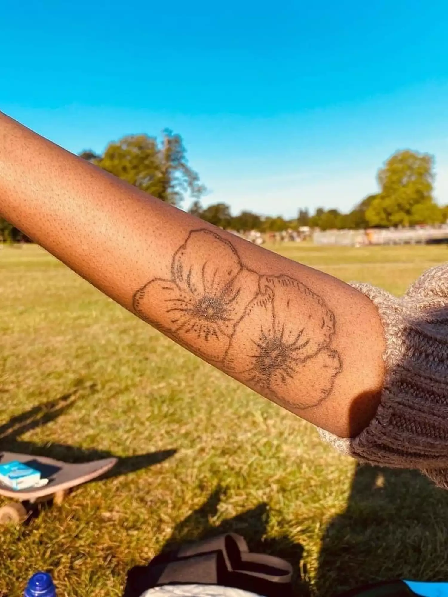 forearm with flower tattoo