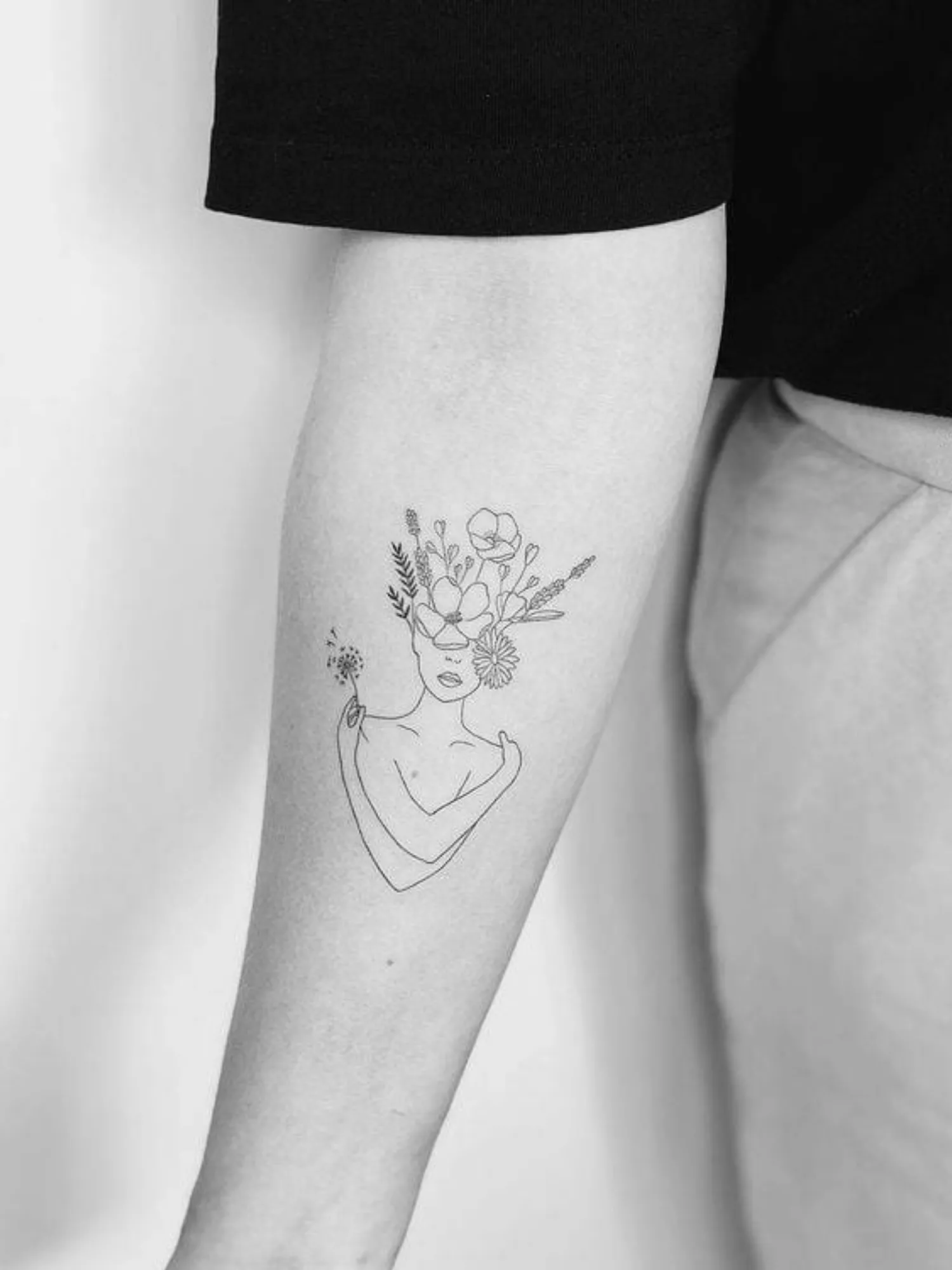 forearm with flower tattoo