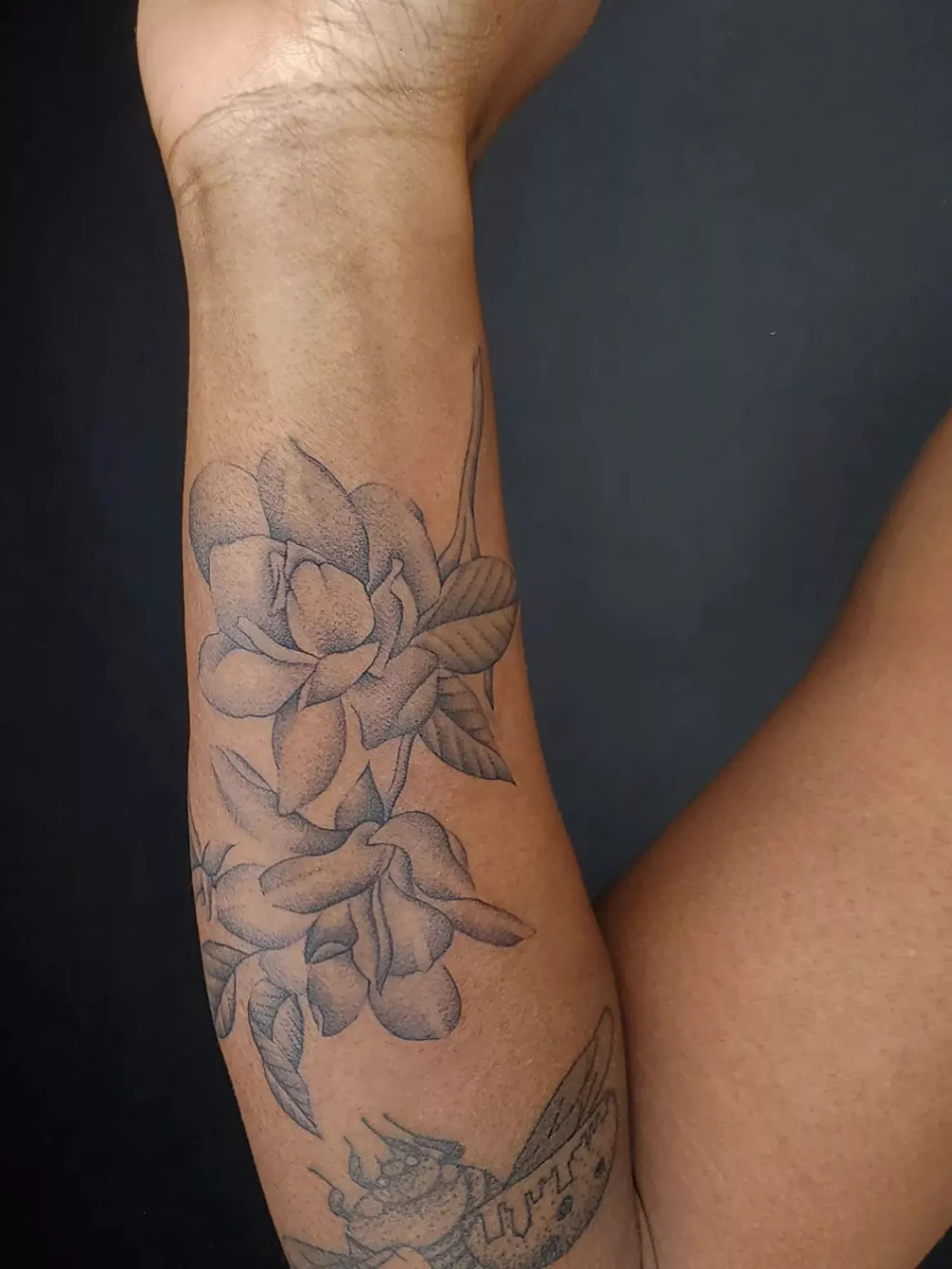 forearm with flower tattoo