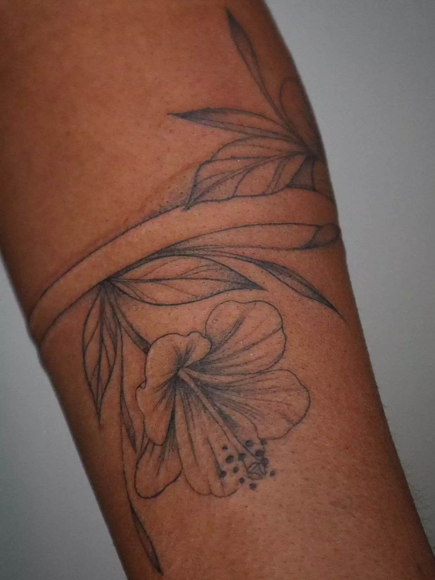 forearm with flower tattoo