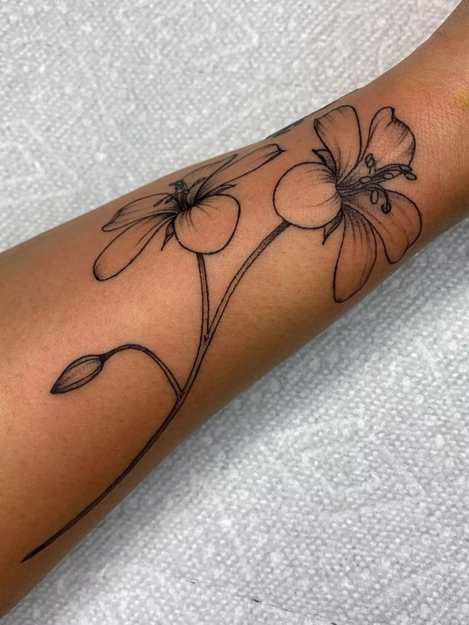 forearm with flower tattoo