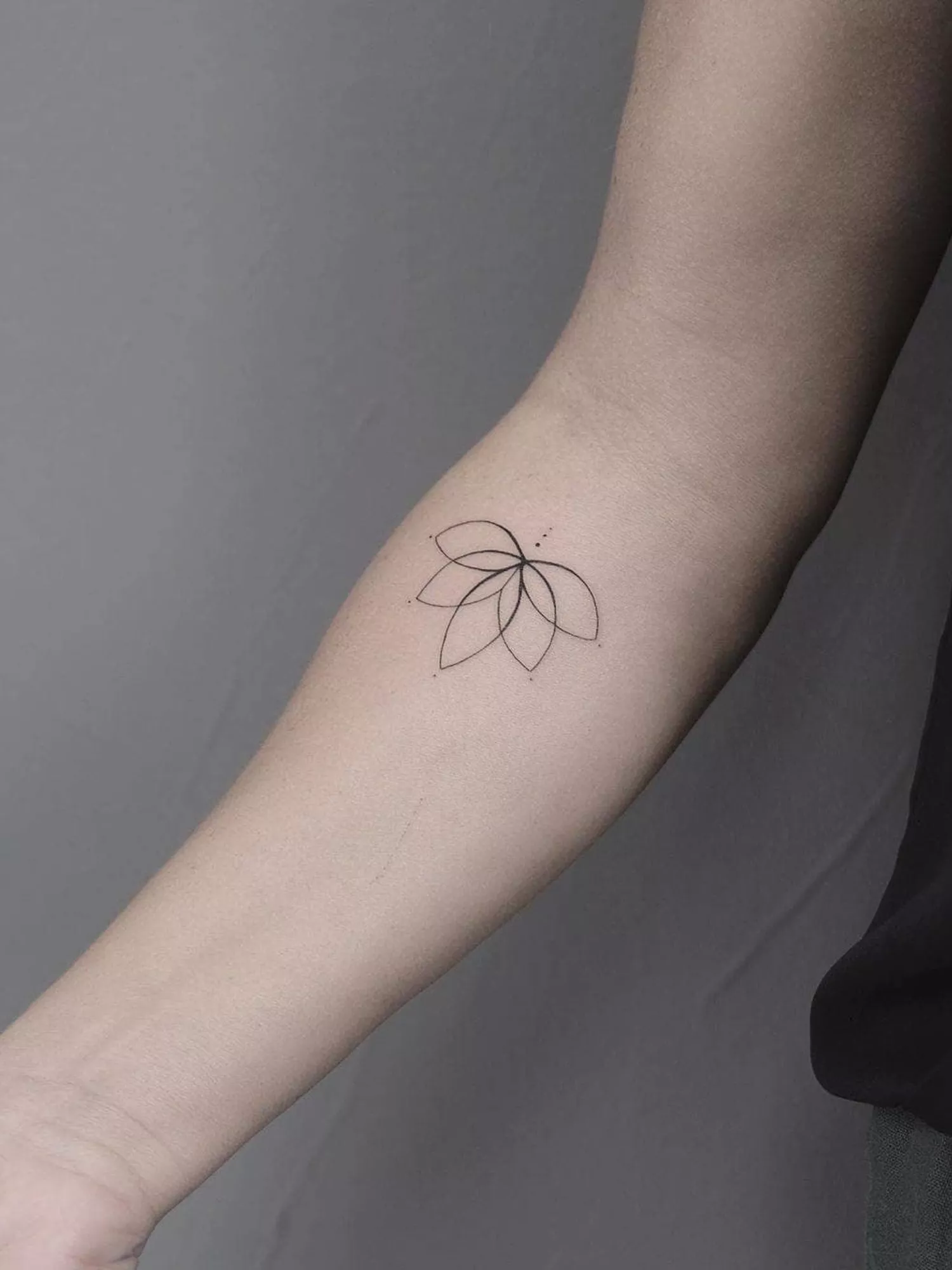 forearm with flower tattoo