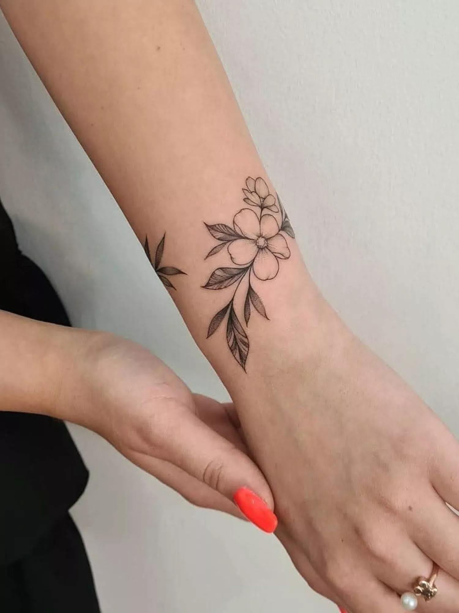 forearm with flower tattoo