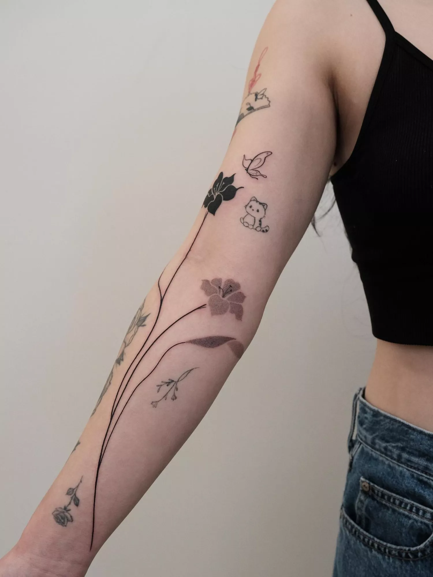 forearm with flower tattoo