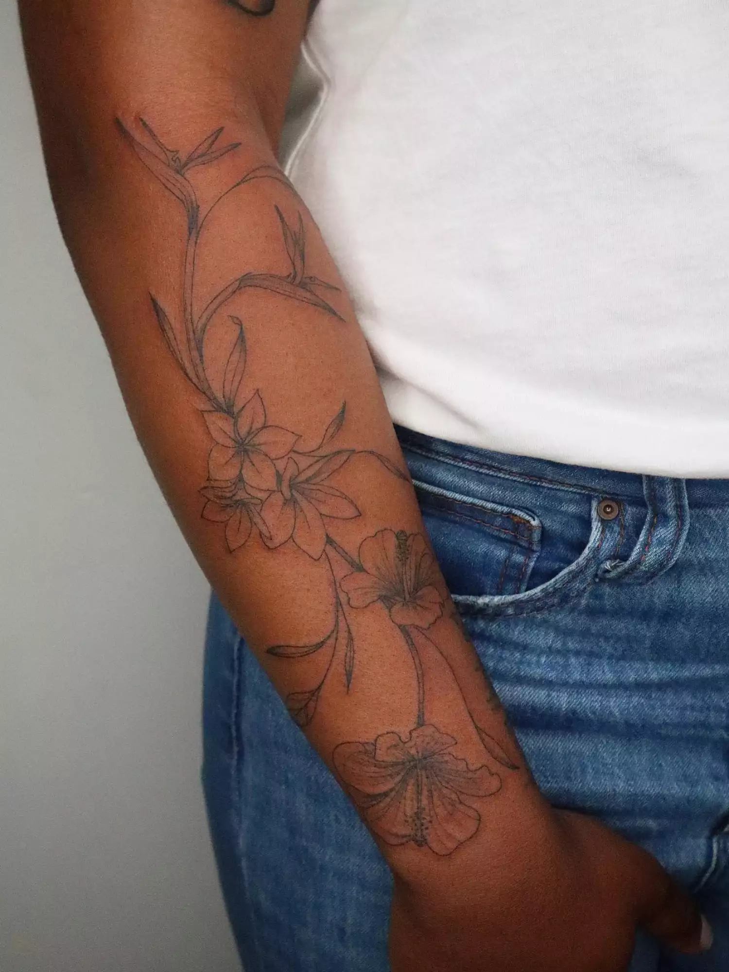 forearm with flower tattoo