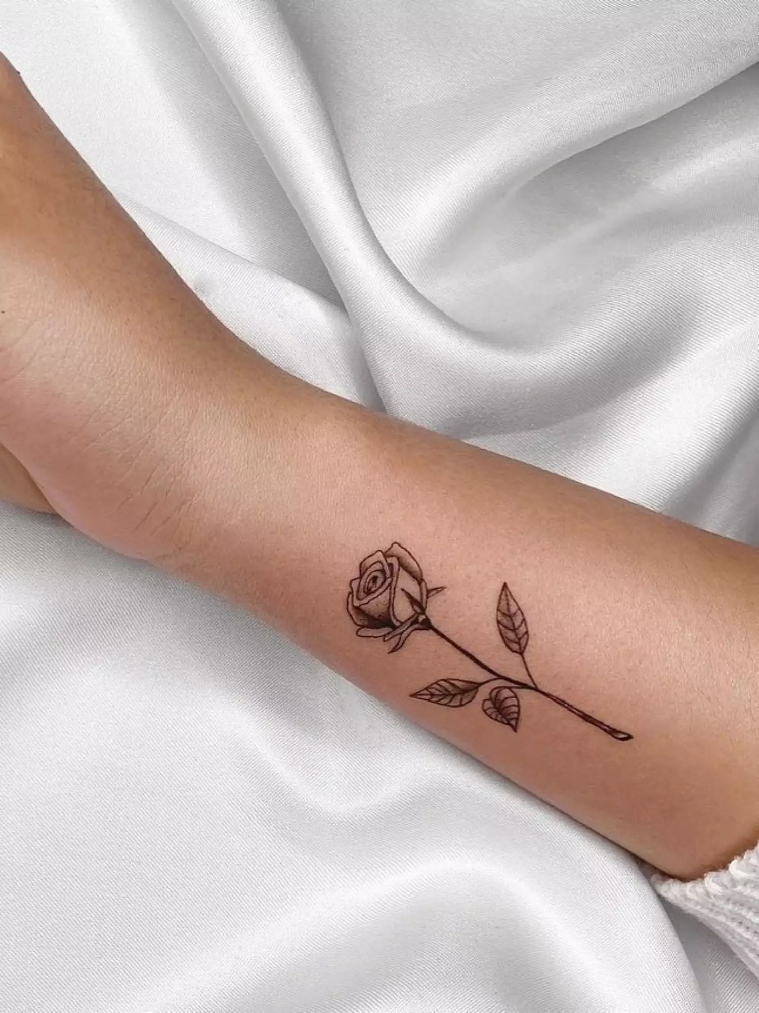 forearm with flower tattoo