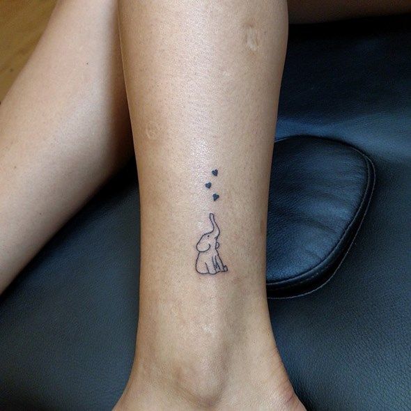 Extremely small elephant tattooed on hand